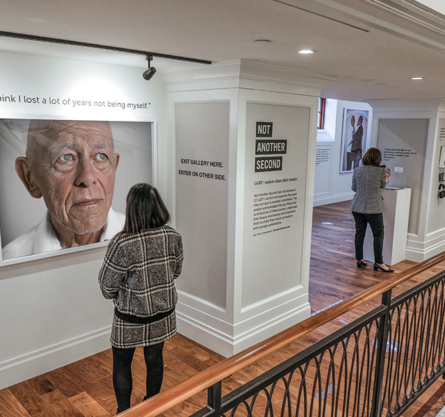 People are looking at the Not Another Second exhibit.