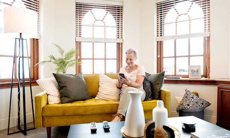 A resident is sitting on a sofa.