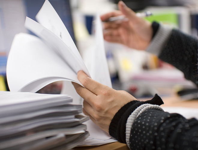 A person is going through papers.
