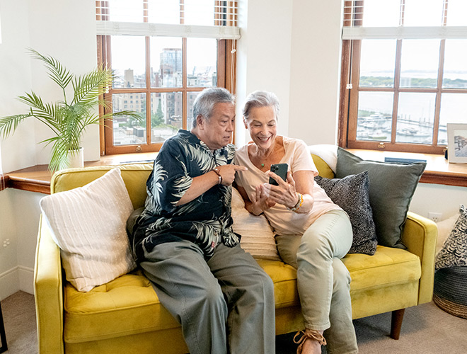 Two residents are looking at a cellphone.
