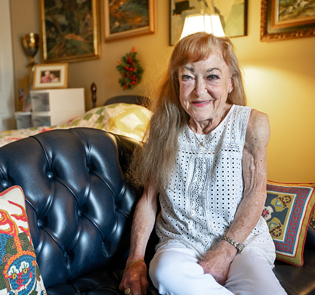 A resident is sitting on the sofa.