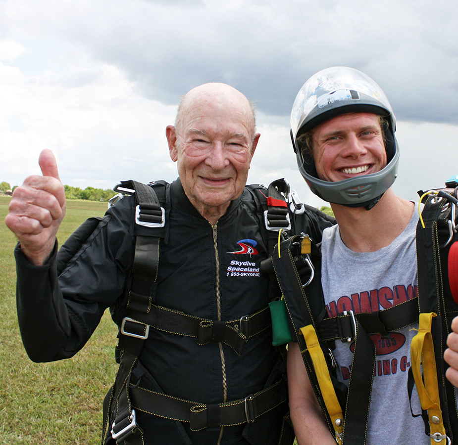 A resident is sky diving with a family member.