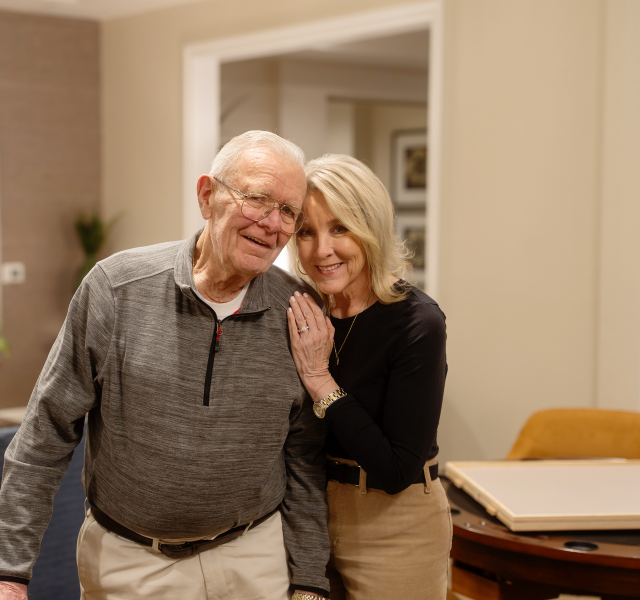 Father and daughter smiling and hugging.