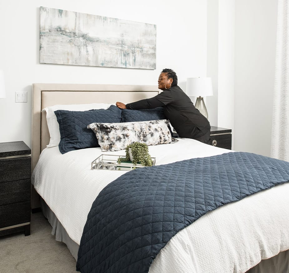 A person is making a bed.