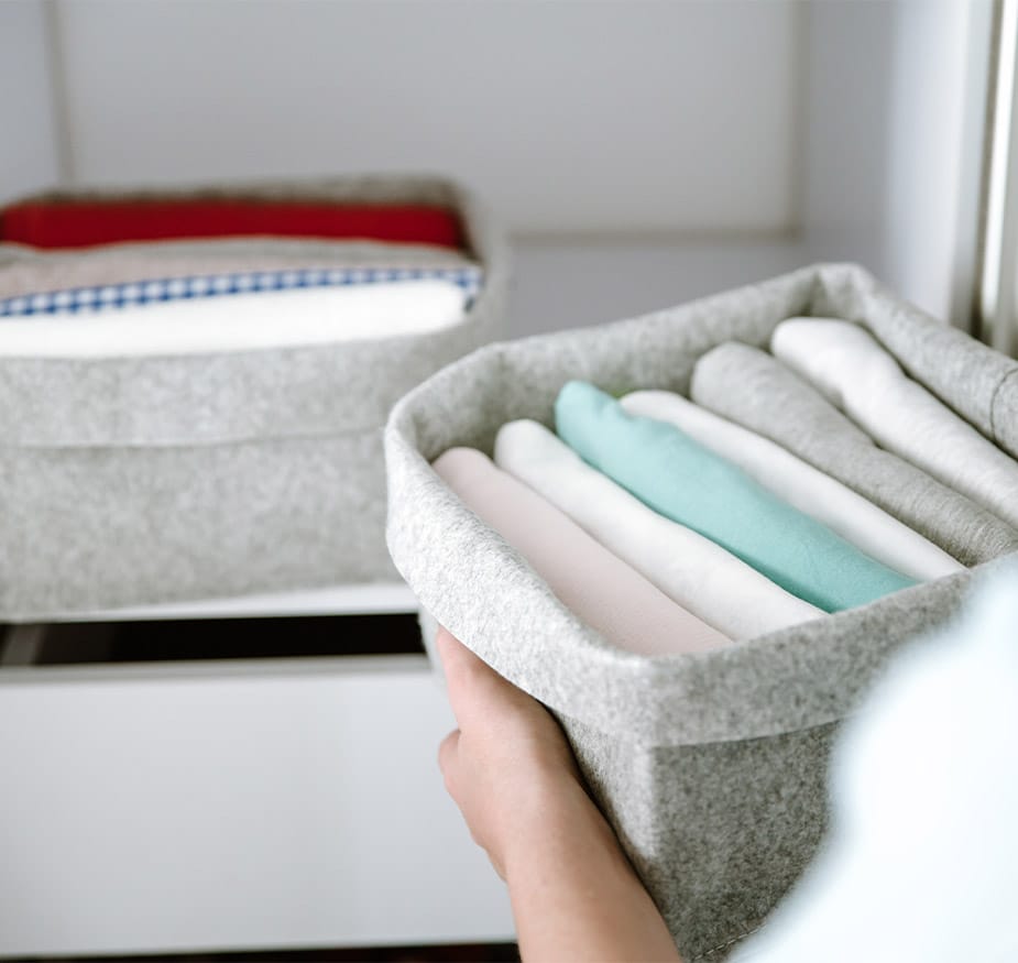 Folded clothes in an organizer container.