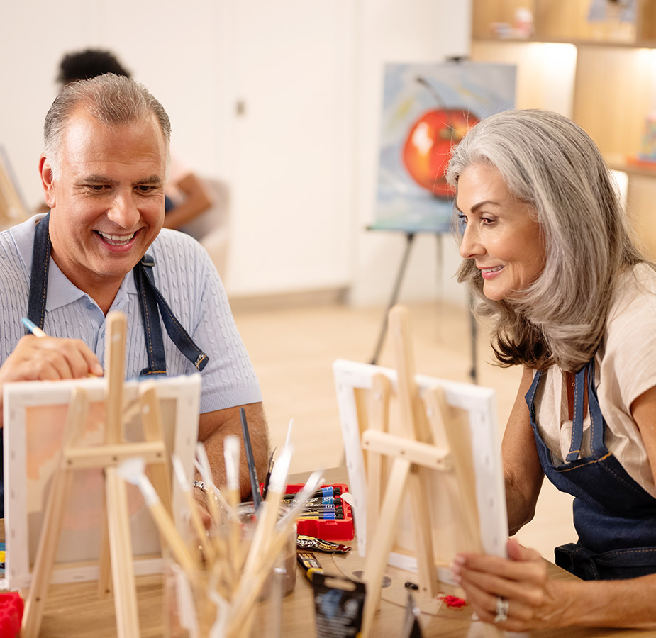 Two people painting in a class.
