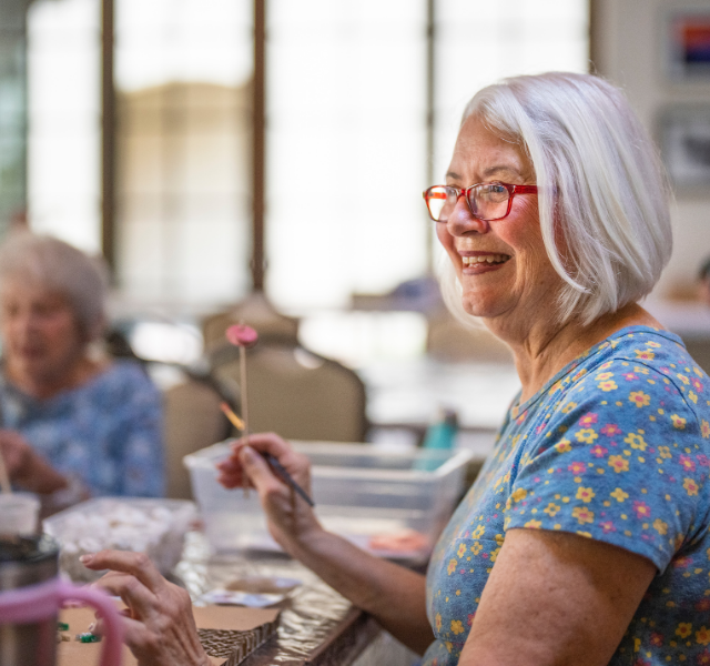Person in an art class, smiling.