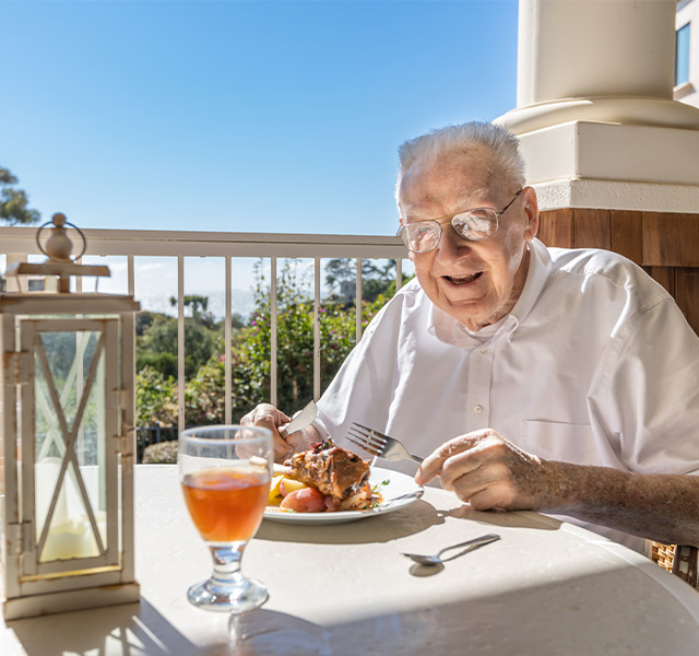 A person eating lunch on the patio.