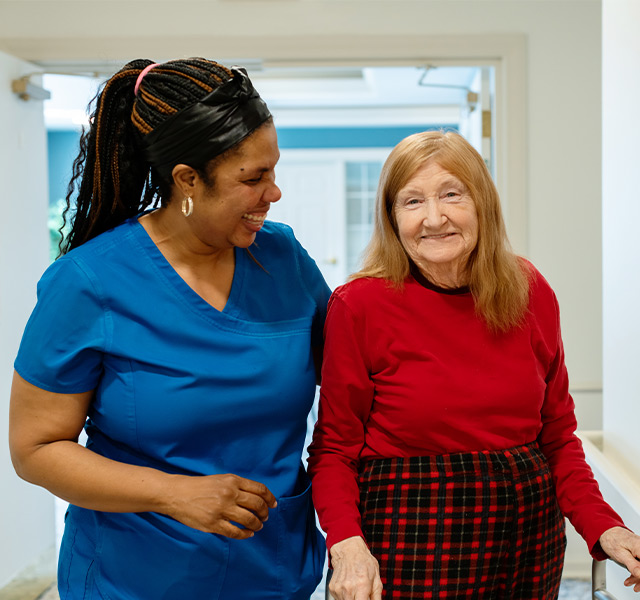 A person walking with a resident.