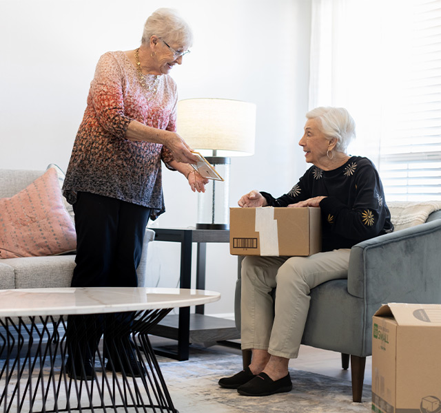 Two people packing boxes.