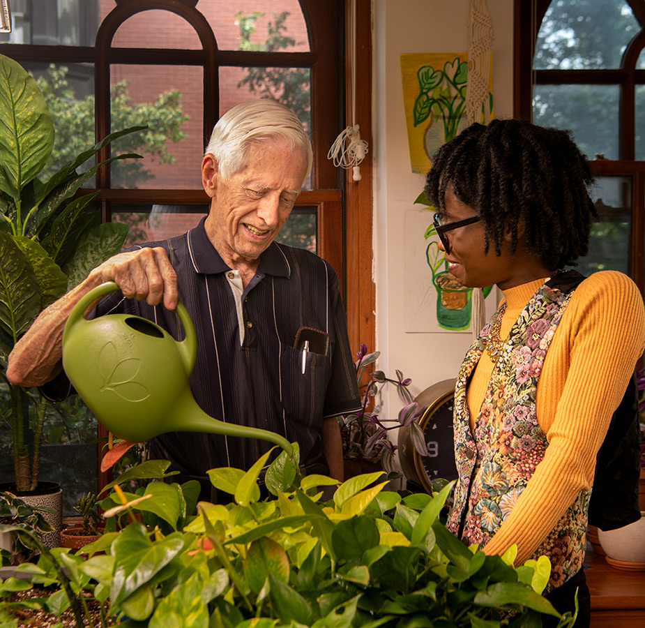 A resident is gardening with a caregiver.