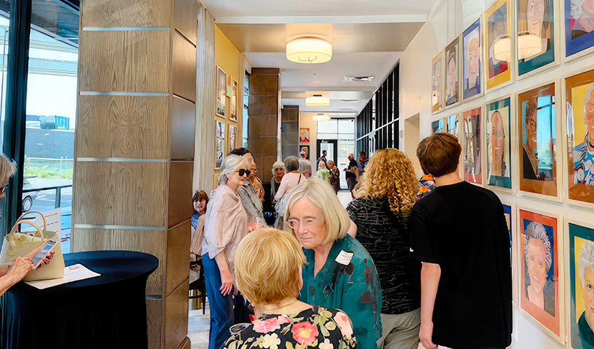 People standing around an art exibit.