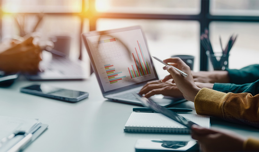 People at a desk on the computer.