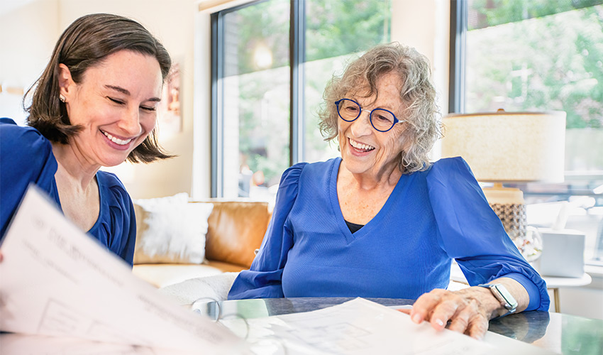 Two people in an office looking at papers.
