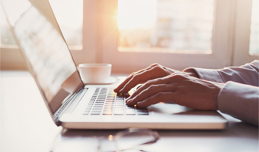 Hands on a computer.