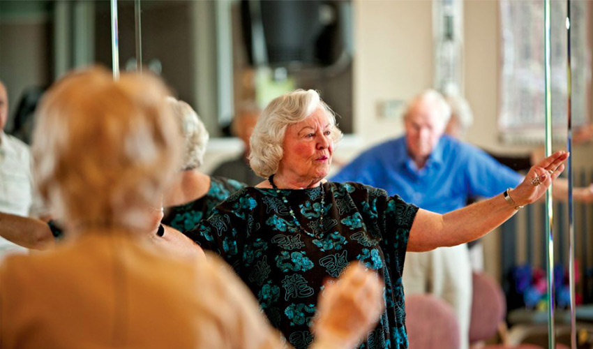 People doing tai chi in a class.