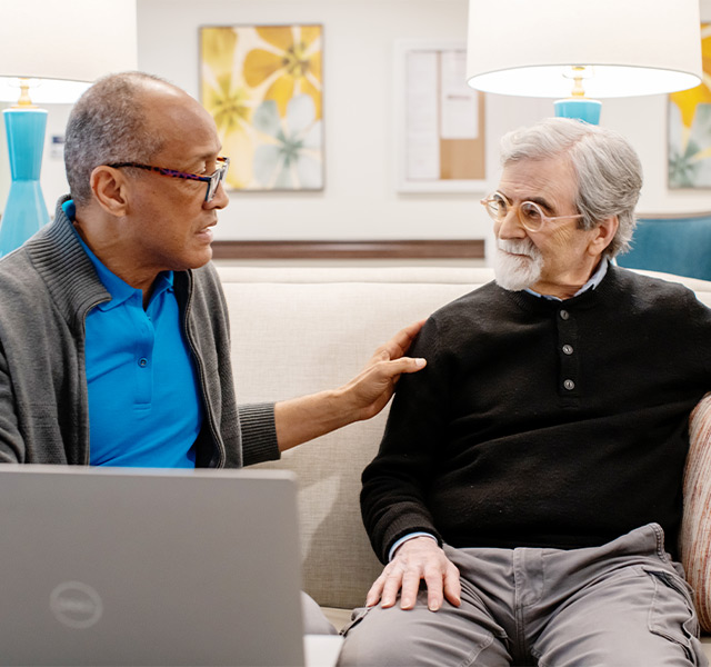 A person explaining technology to another.