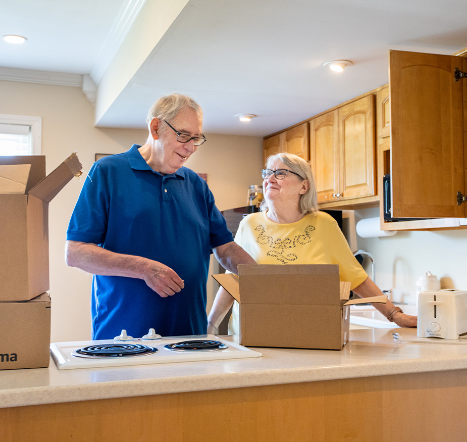 Two people packing a box.