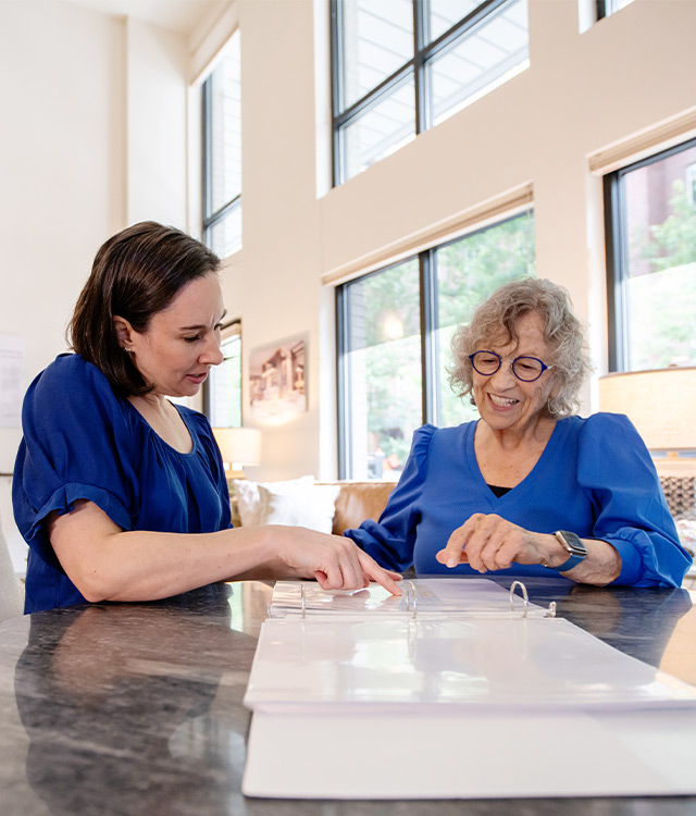 Two people looking at a pamphlet. 