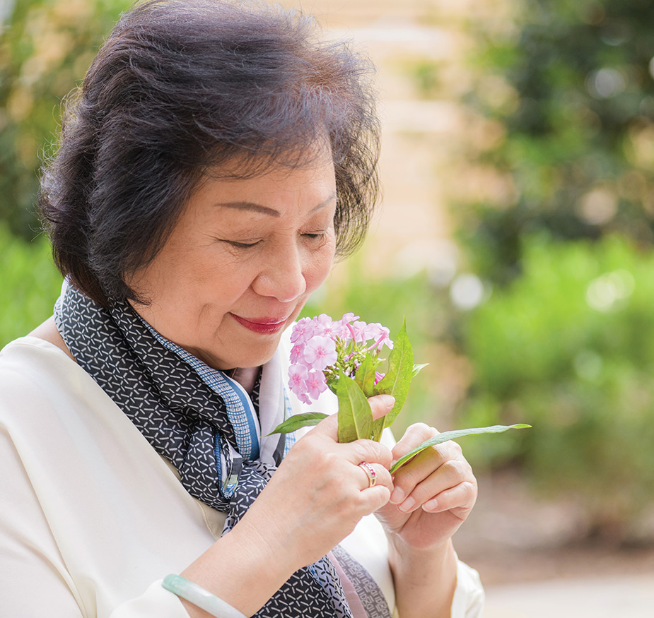 A person smelling a flower.