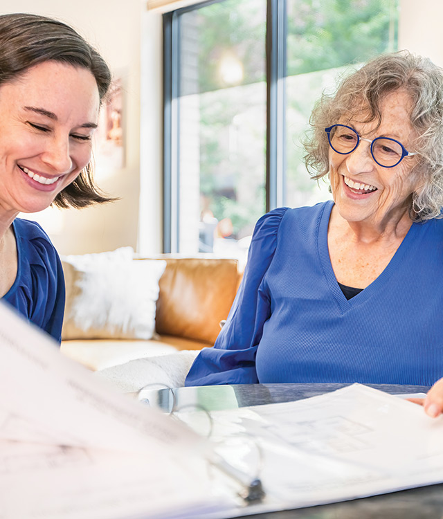 Two people looking over papers.