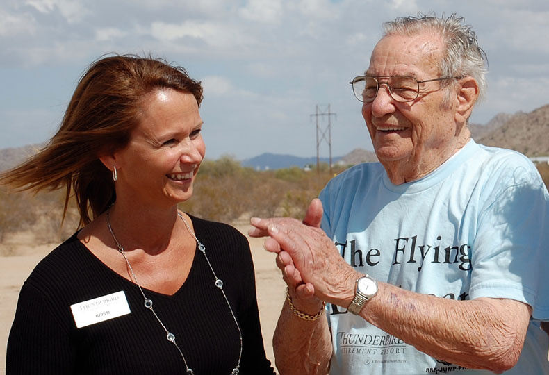a Watermark associate with an elderly man at the beach