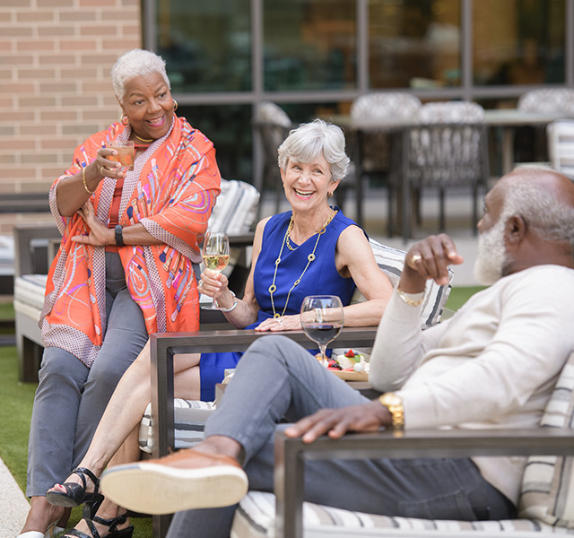 A group of residents outside having drinks.