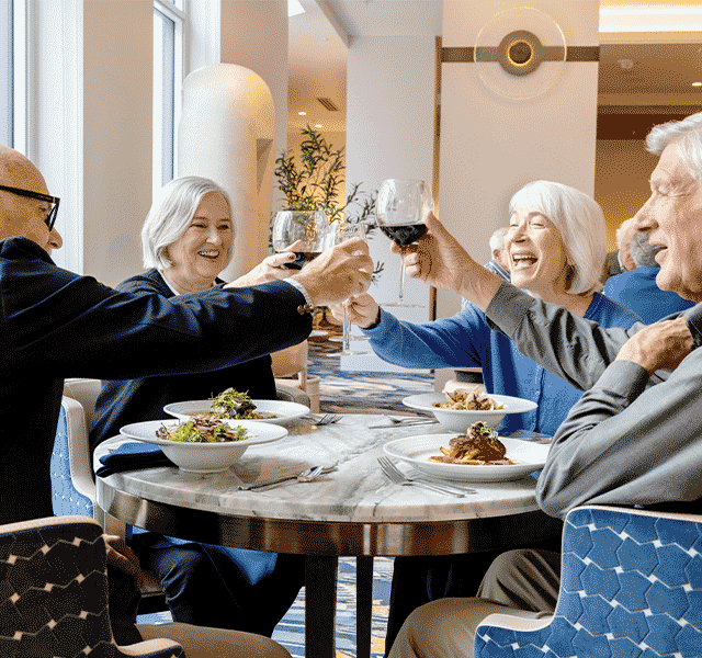 A group of people toasting with wine.
