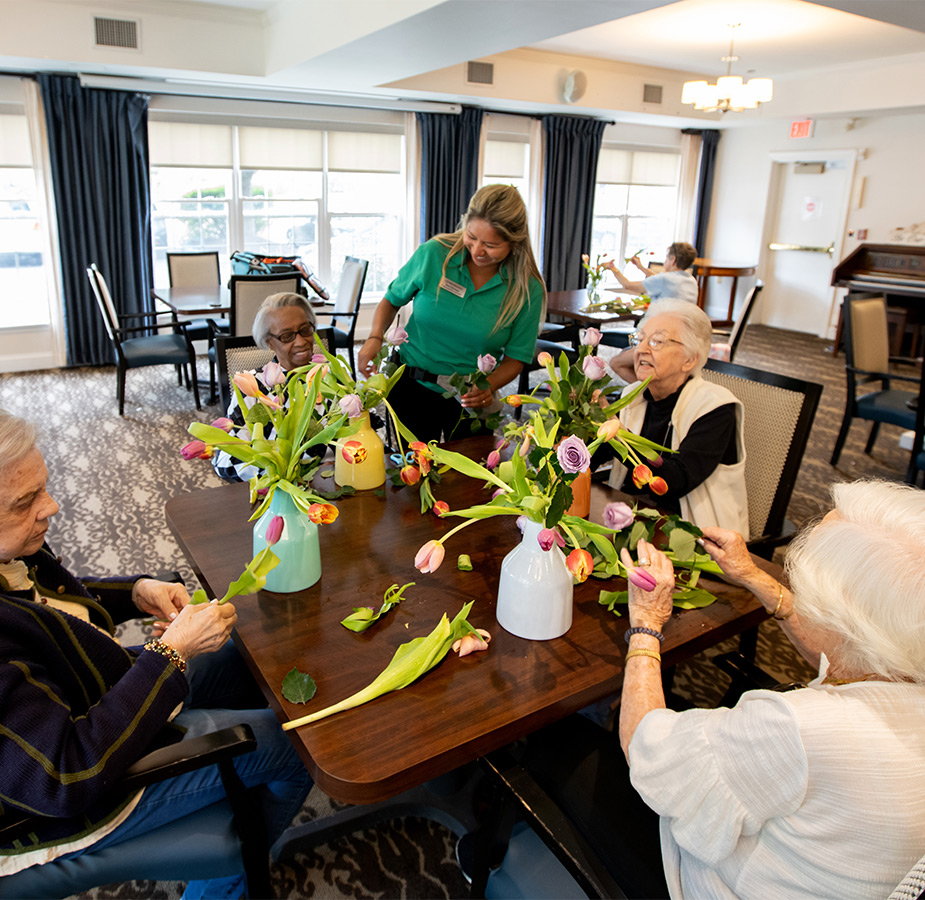 People at a table arranging flowers.