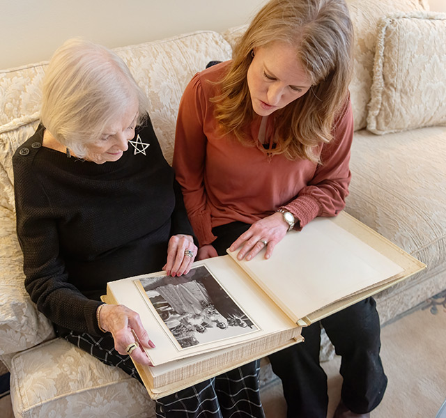 A resident showing someone their photo album.