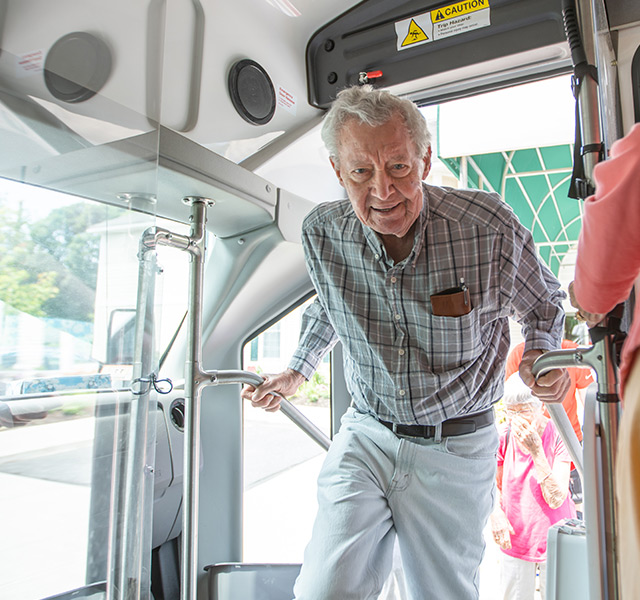 A resident is getting on a bus.
