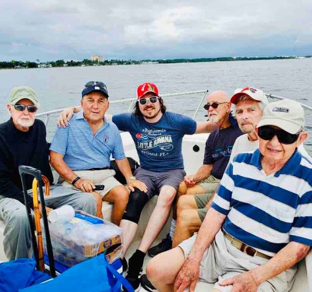 A group of male residents on a boat together.
