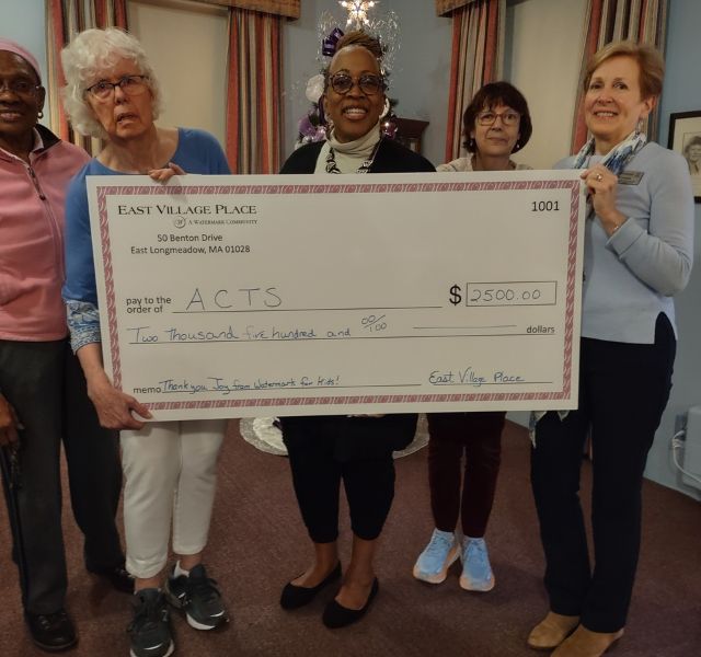 People holding large check with $2,500 donation.
