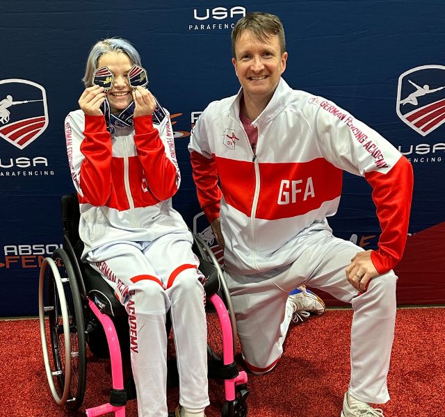 Cora is with her coach at the Paralympics.