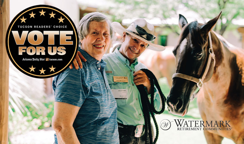 Two women are standing next to a horse.