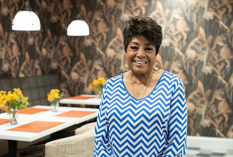 A resident standing in a restaurant.