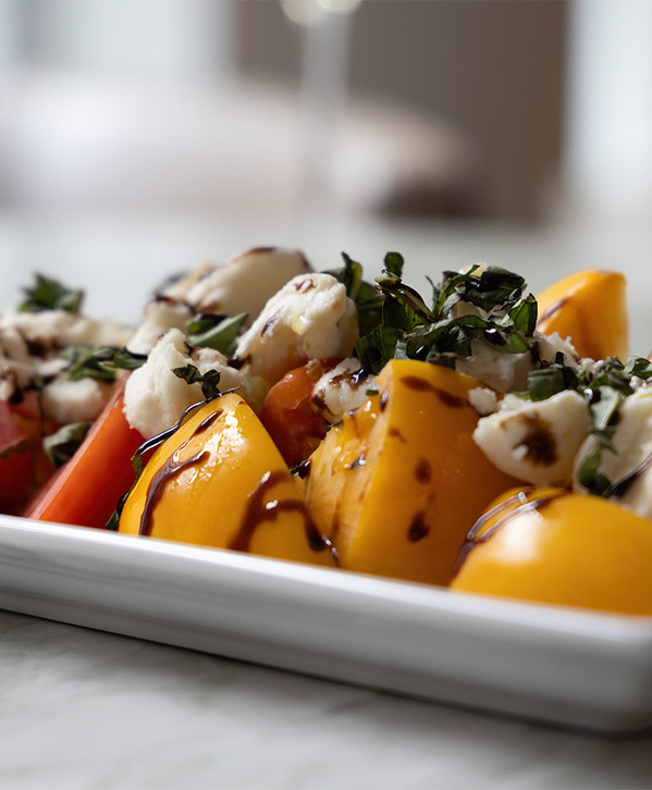 A caprese salad on a plate. A caprese salad on a plate.