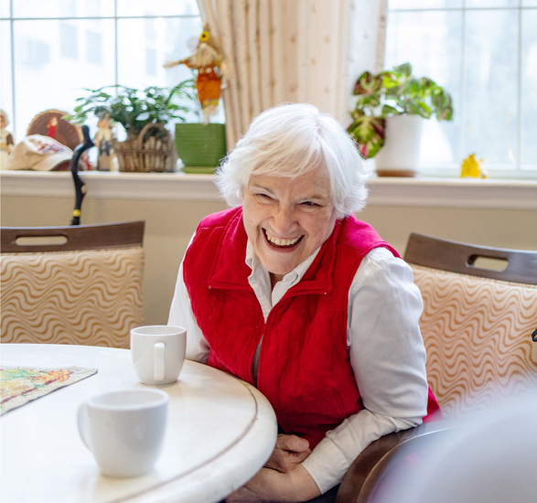 A person sitting and laughing.