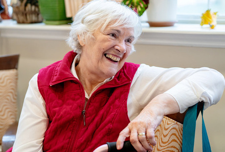 A person sitting and smiling.