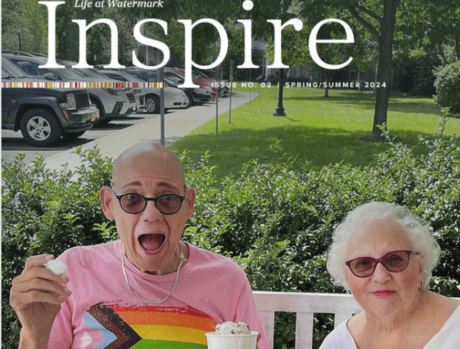 Two residents eating ice cream outside on a bench.