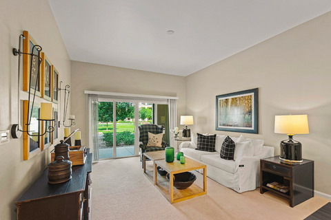 Furnished living room space with sofa, table, and seating area.