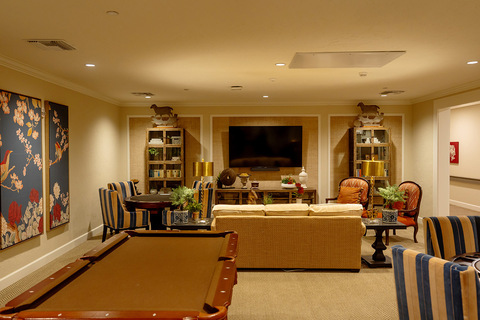A game room with a pool table.