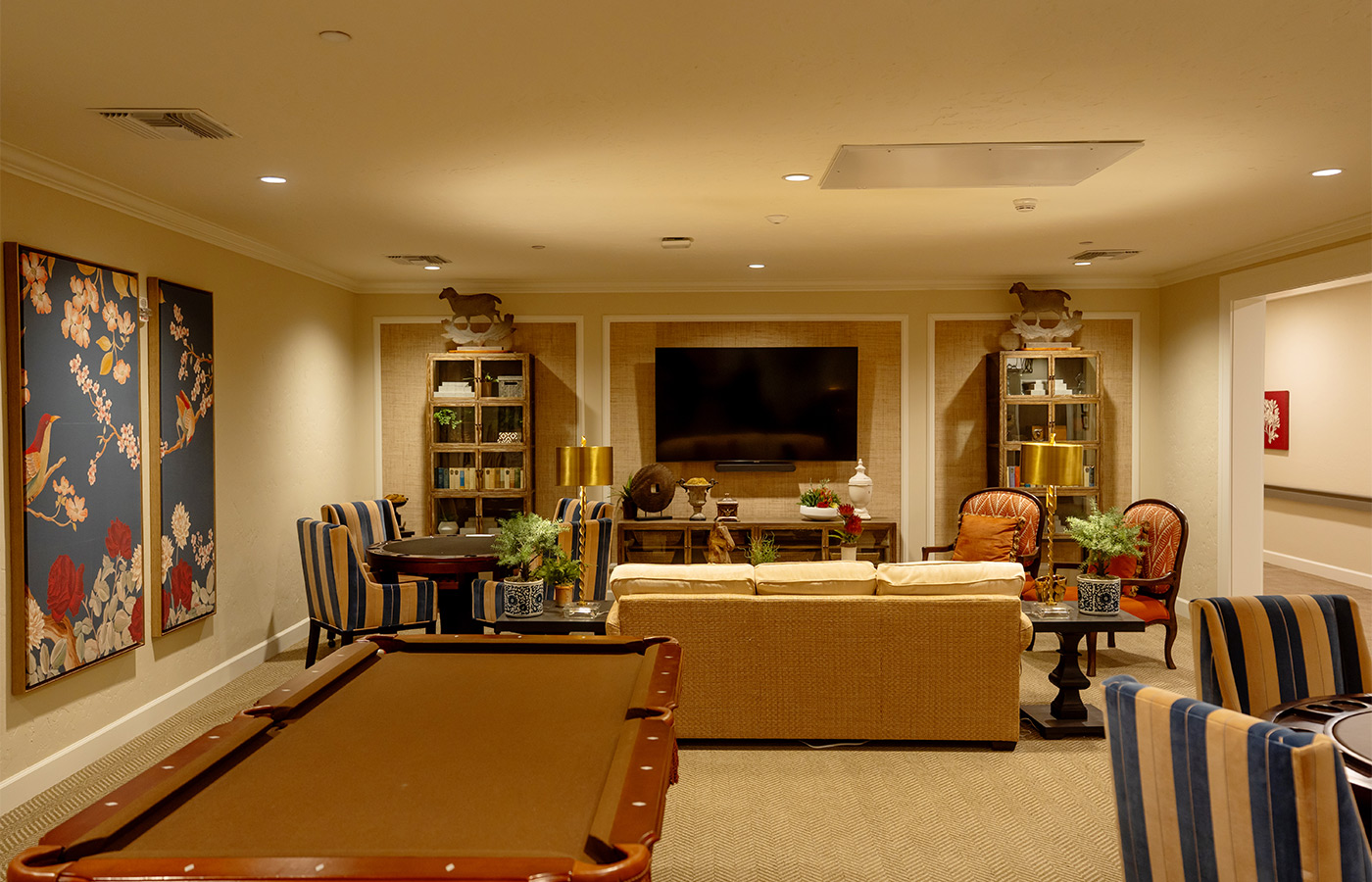 A game room with a pool table.