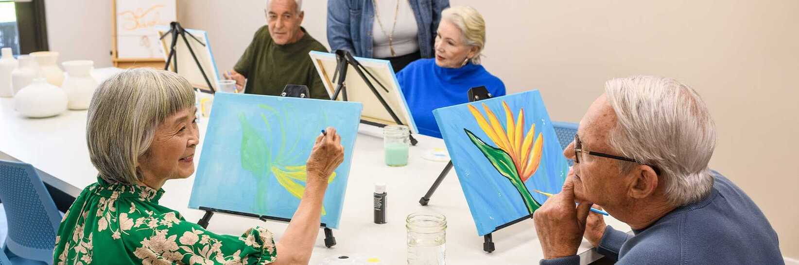 Residents enjoying an art class. Residents enjoying an art class.