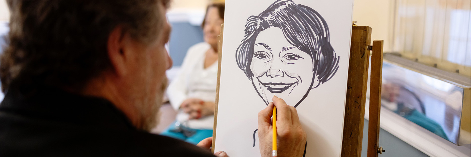 A person drawing another.
