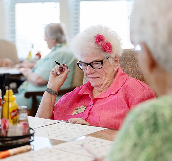 A resident in pink playing bingo.