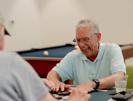 Two people playing a card game.