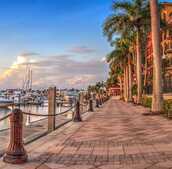 Beachfront with ships and buildings.