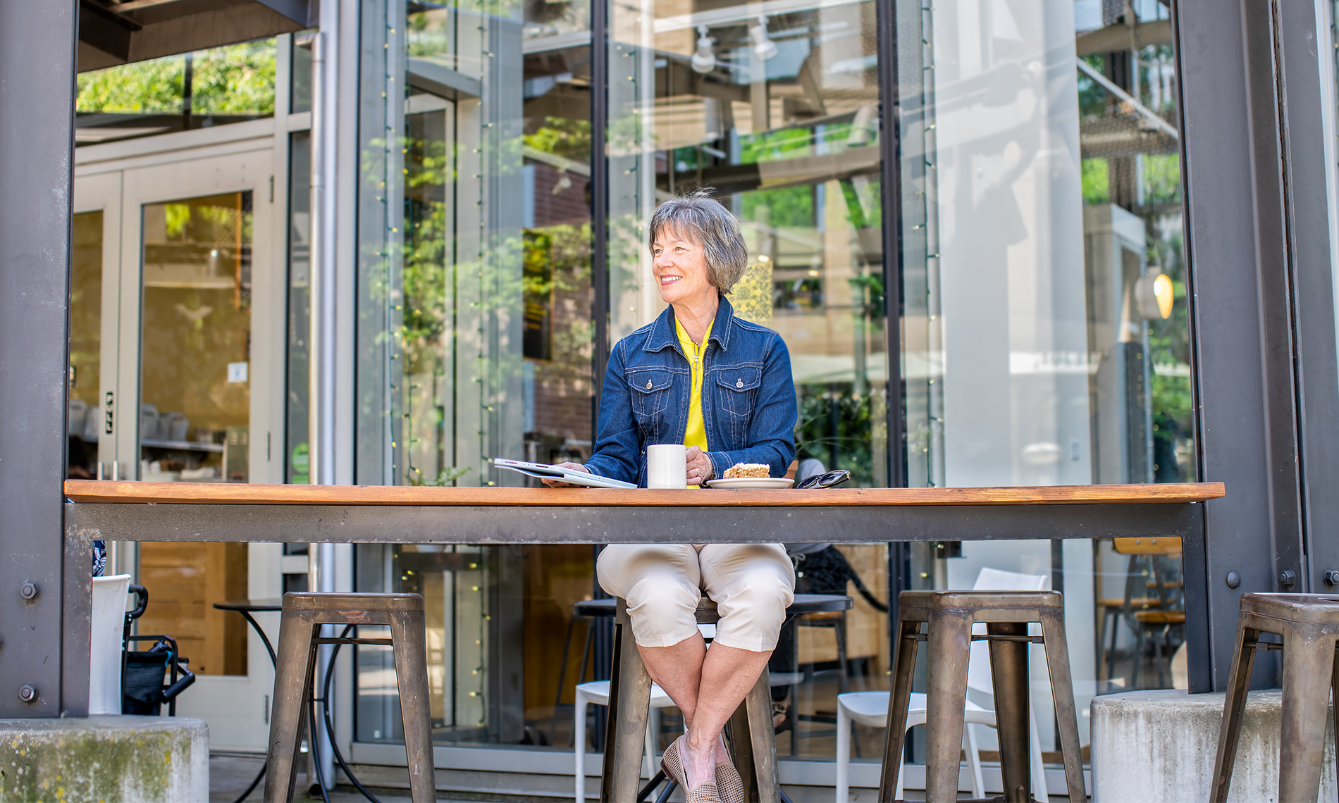 A person sitting having coffee at The Watermark at The Pearl, an independent living community in Portland.