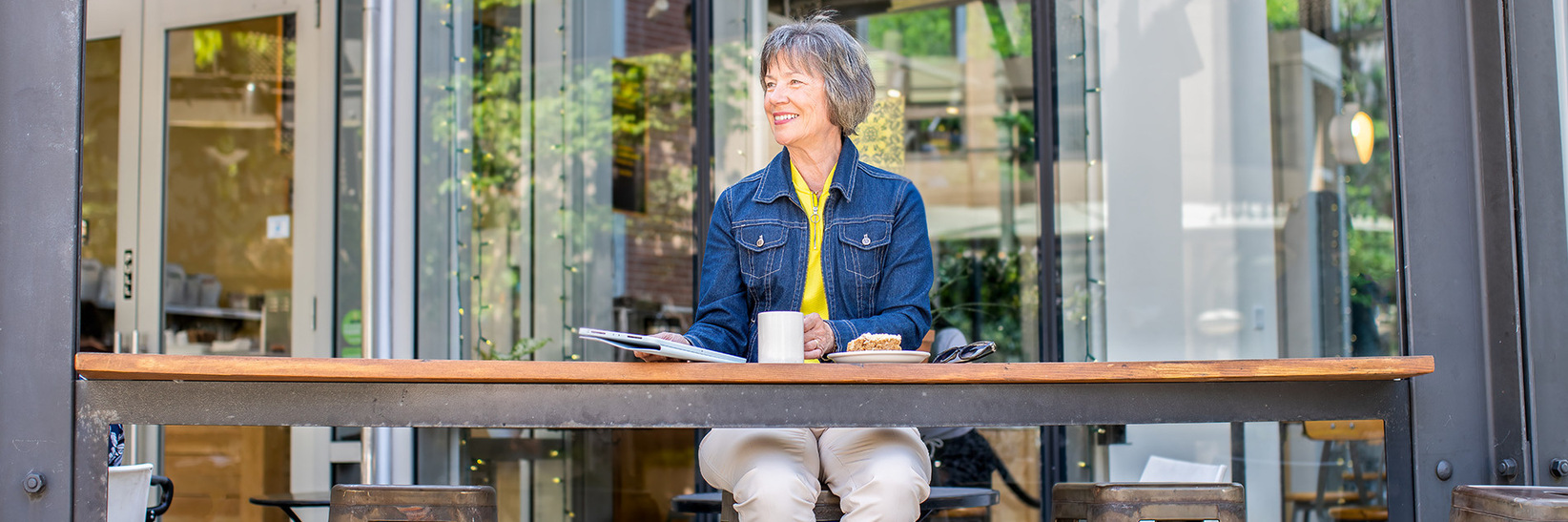 A person sitting having coffee at The Watermark at The Pearl, an independent living community in Portland. A person sitting having coffee at The Watermark at The Pearl, an independent living community in Portland.